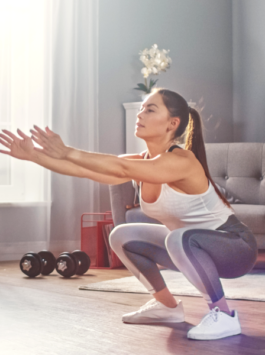 Frau macht zuhause die Bodyweight Übung Squats