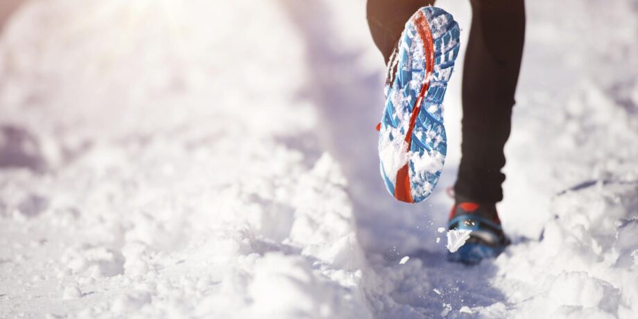 Läufer mit grob profilierter Sohle beim Lauftraining im Schnee