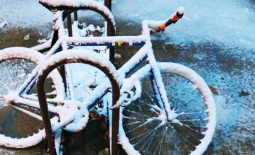 eingeschneite Fahrräder in einem Fahrradständer