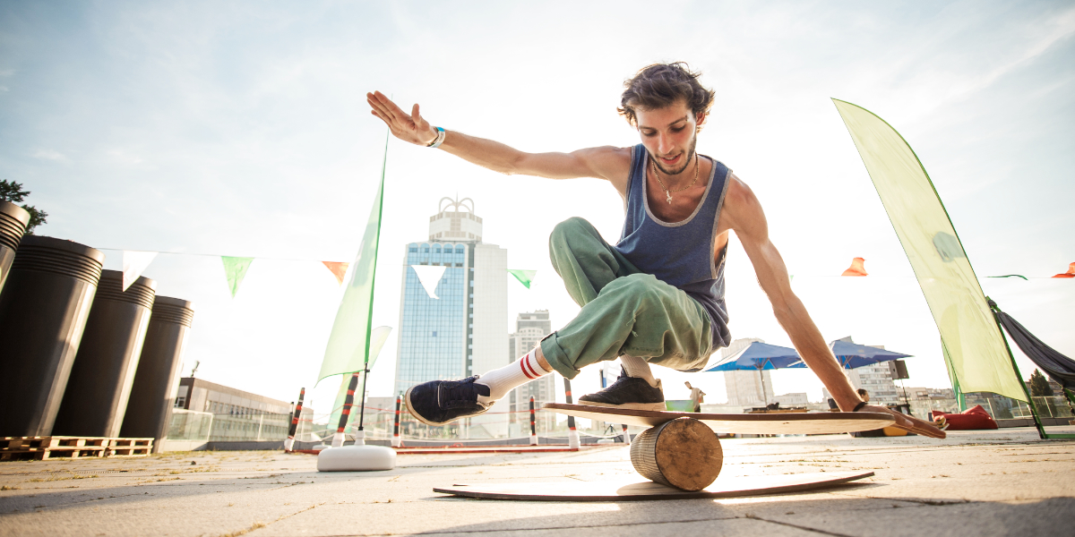 Surfer übt auf einem Balance Board sein Gleichgewicht zu halten