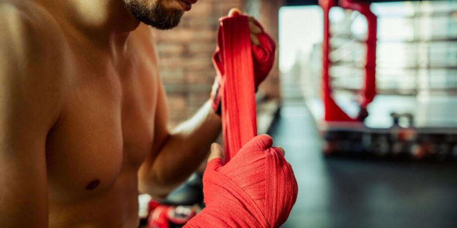Boxer bindet sich eine Bandage um die Hand