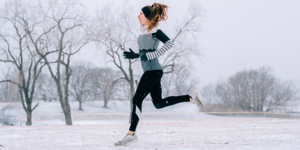 Frau joggt im Winter im Schnee
