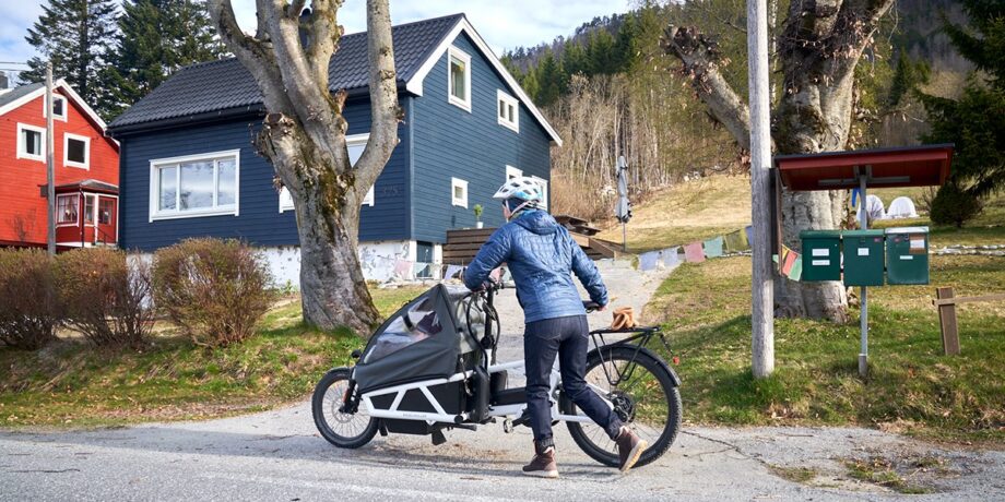 Katrin Schneider schiebt ihr Kind an norwegischen Häusern vorbei