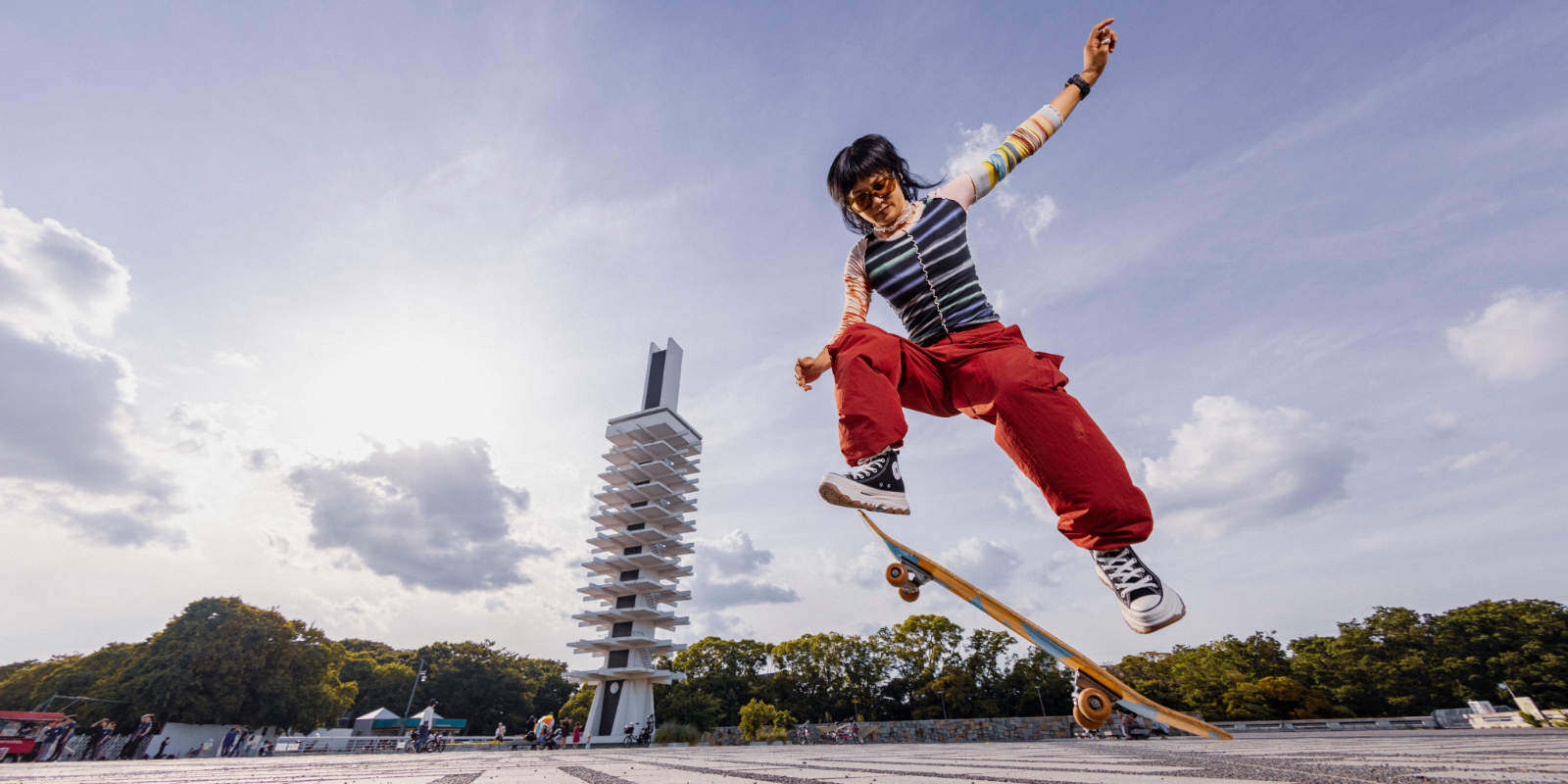 Junge Frau auf dem Skateboard mit Garmin Instinct 3 am Handgelenk