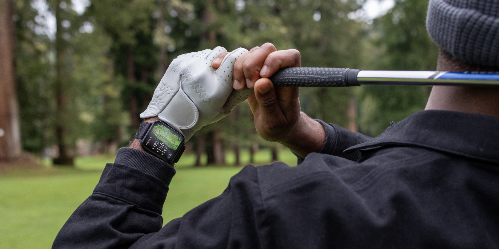 Golfspieler nach dem Abschlag mit einer Garmin Venu X1 am Handgelenk, die eine Golfkarte anzeigt