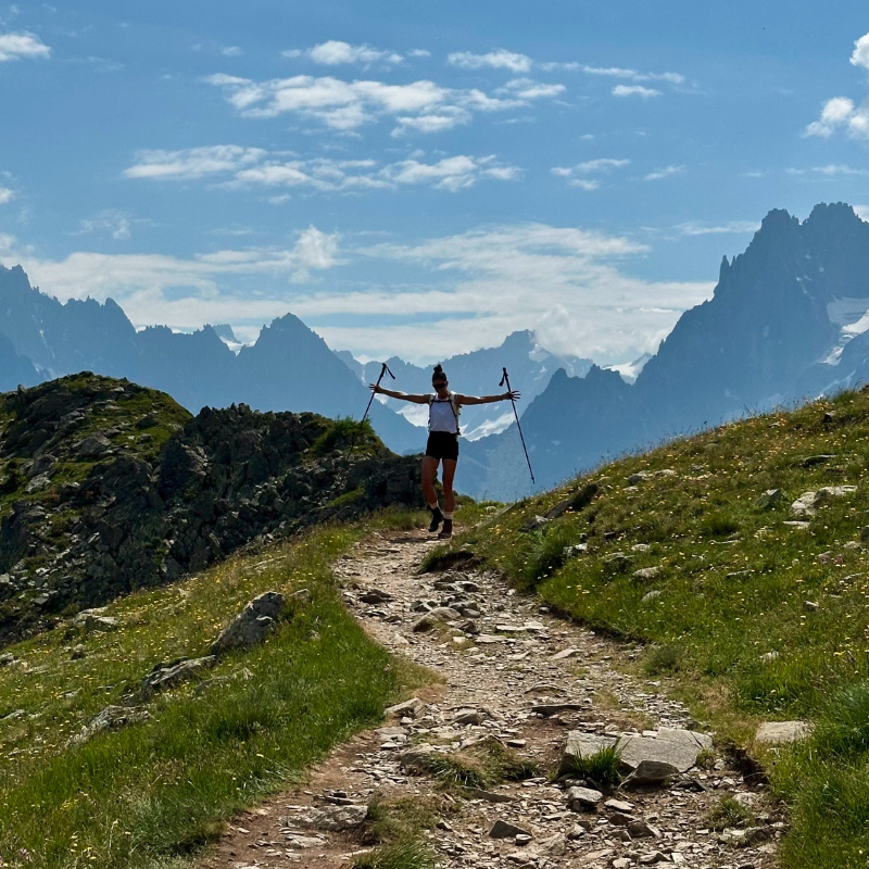 Katja Tegler hält ihre Trailrunningstöcke beim Laufen in die Luft